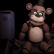 A creepy Freddy Fazbear animatronic sits in a dark room.